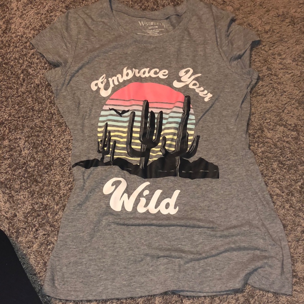 Grey T-shirt with embrace your wild wording and cactus setting.